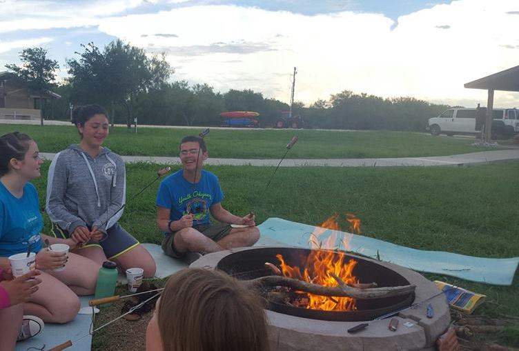 Summer leaderships camps laughing campers eating smores