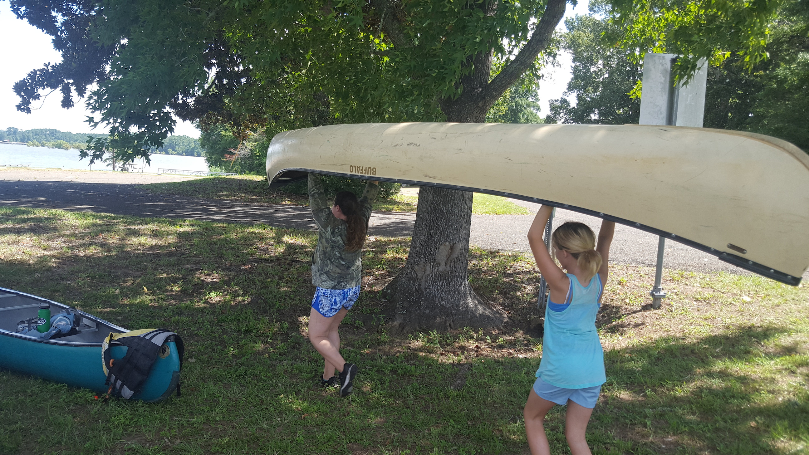 Girls carrying a canoe at our summer leadership camp